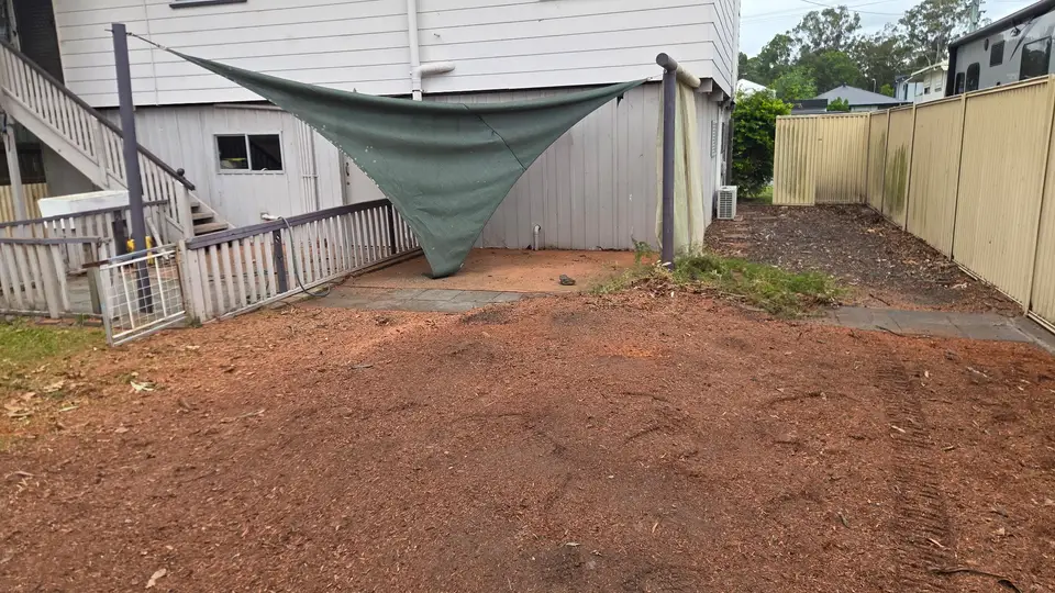 The same courtyard with the stump gone and the ground raked flat and level